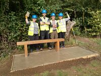 Volunteers from Vodafone laying a base to the second bench, October