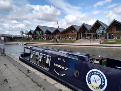 Trip boat Dragonfly at landing stage with H&W pub in background